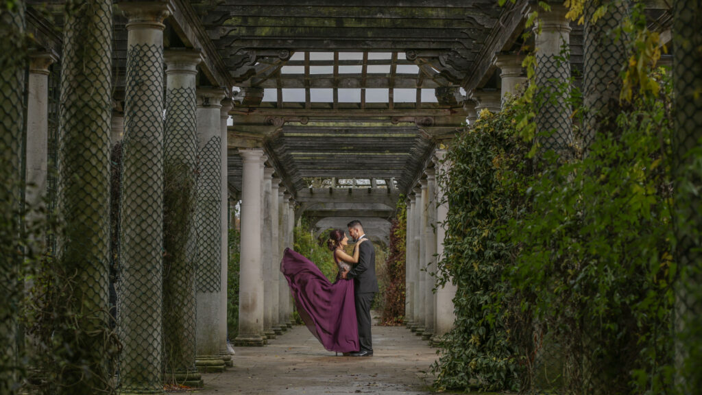 Couple together beneath a garden pergola