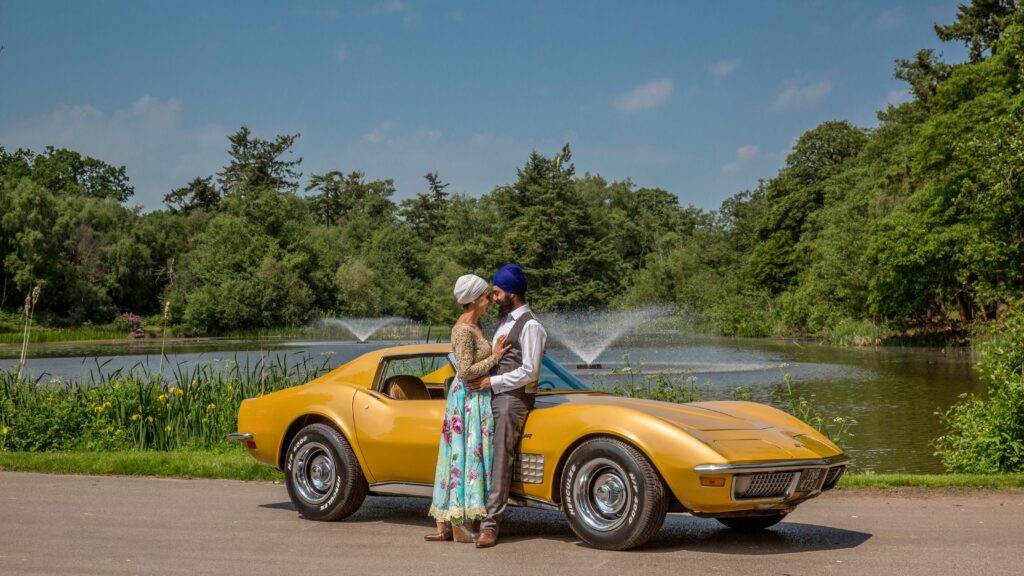 Couple beside a yellow vintage car
